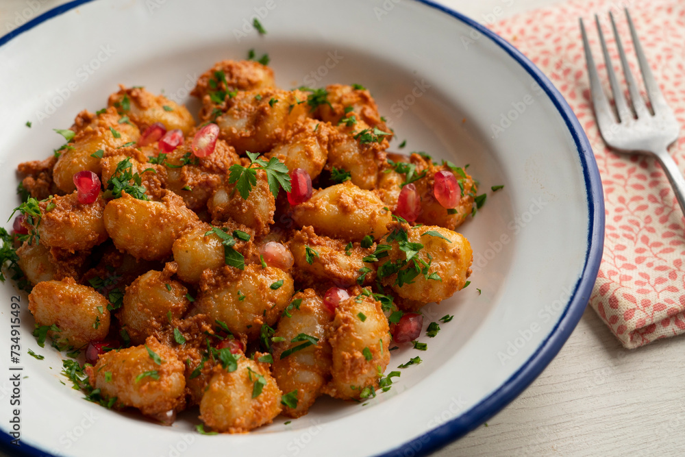 Gnocchi with pesto rosso sauce. Italian potato gnocchi with traditional sauce. Gnocchi with pesto rosso sauce. Italian potato gnocchi with traditional sauce.