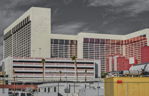 Neon signs, glitz casino hotel resorts, traffic and highrise city skyline in superlative gambling wedding party destination Las Vegas, Nevada with strip traffic street scene and modern architecture