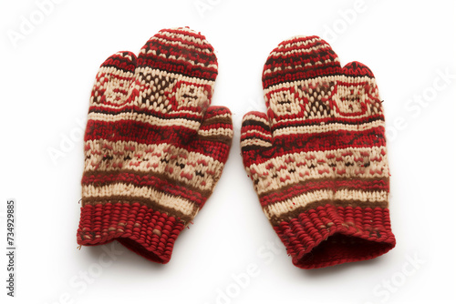 A pair of knitted mittens with a patterned design isolated on white background