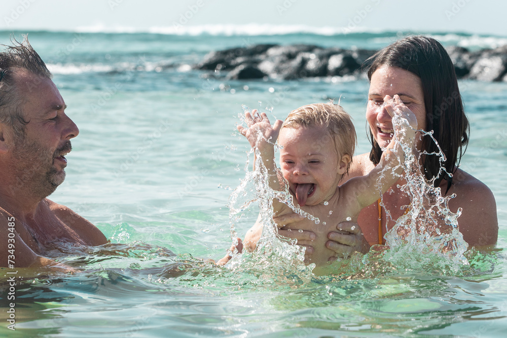 Joyful family moment with toddler with down syndrome in the sea Joyful family moment with toddler with down syndrome in the sea