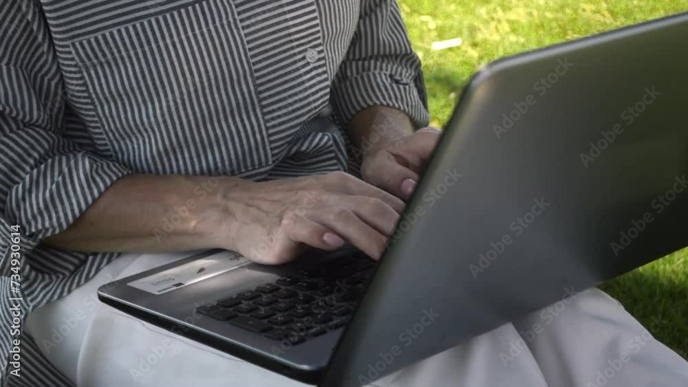 women works at laptop. learning online for old people. work online. freelance for old people. women working in park. An elderly women works outside the office on a warm summer day. Working outside. women works at laptop. learning online for old people. work online. freelance for old people. women working in park. An elderly women works outside the office on a warm summer day. Working outside.