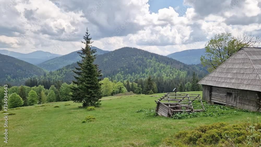 Mountain meadow with wooden herdsman hut in the Carpathian Mountains Mountain meadow with wooden herdsman hut in the Carpathian Mountains