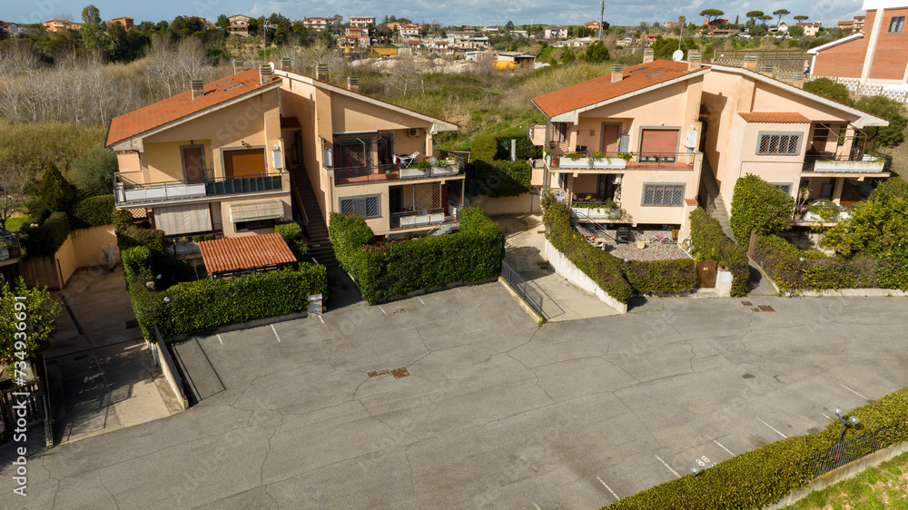 Aerial view on small terraced villas built in a residential area. All houses have their own garden. Aerial view on small terraced villas built in a residential area. All houses have their own garden.