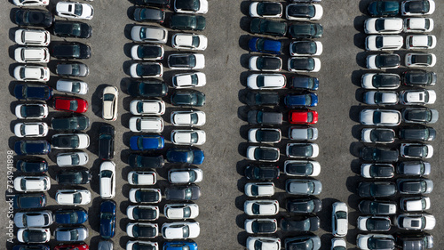 Perpendicular aerial view of many cars parked and ready for sale and distribution on the international market.