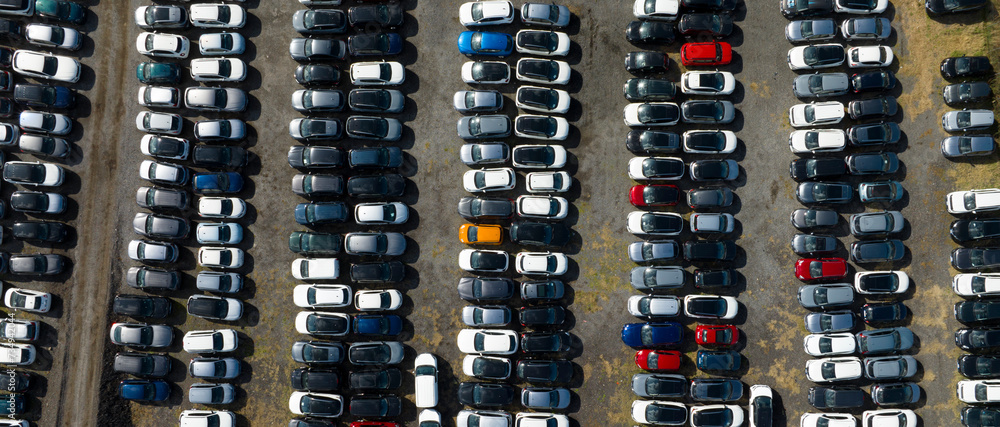 Perpendicular aerial view of many cars parked and ready for sale and distribution on the international market. Perpendicular aerial view of many cars parked and ready for sale and distribution on the international market.