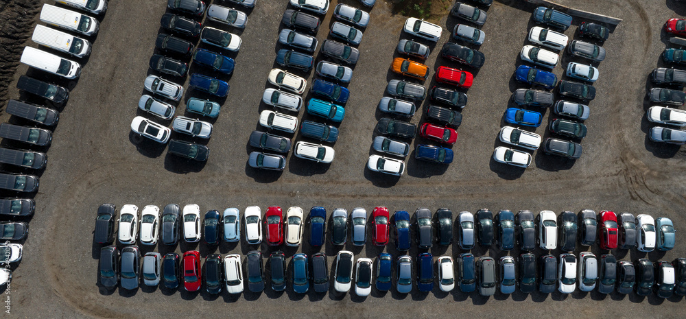 Perpendicular aerial view of many cars parked and ready for sale and distribution on the international market. Perpendicular aerial view of many cars parked and ready for sale and distribution on the international market.