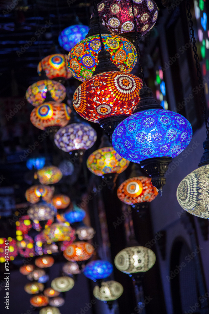 Doha, Qatar-April 20,2023: In the Old market Souk Waqif a decorative, traditional, glass mosaic lamps hanging.