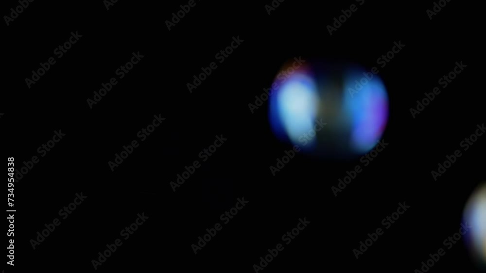 Lot of Large Colorful Soap Bubbles Fly on a Black Background and Burst. Blowing. Splash, foam. Fast blurry motion. Abstract, texture. Selective focus. Empty space. Isolated on black. Illumination. Lot of Large Colorful Soap Bubbles Fly on a Black Background and Burst. Blowing. Splash, foam. Fast blurry motion. Abstract, texture. Selective focus. Empty space. Isolated on black. Illumination.