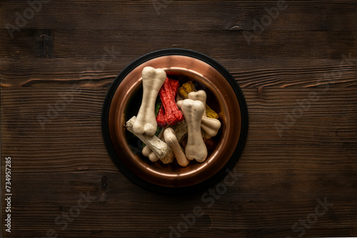 Bowl full of chew bones for dog. Food and treats for pets