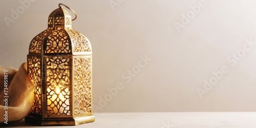 Golden Ramadan Lantern on a white background. Ramadan Kareem background with space for text. Traditional Arabic lamp with burning candle