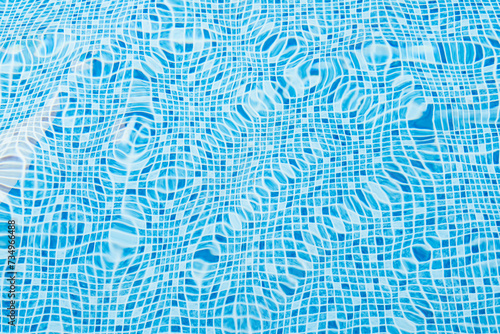 Rippling water surface in a bright blue tiled pool photo