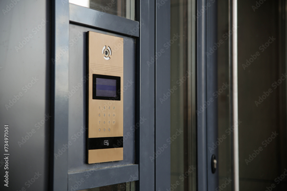 Modern entrance doorbell intercom in apartment building, with a video surveillance camera Modern entrance doorbell intercom in apartment building, with a video surveillance camera