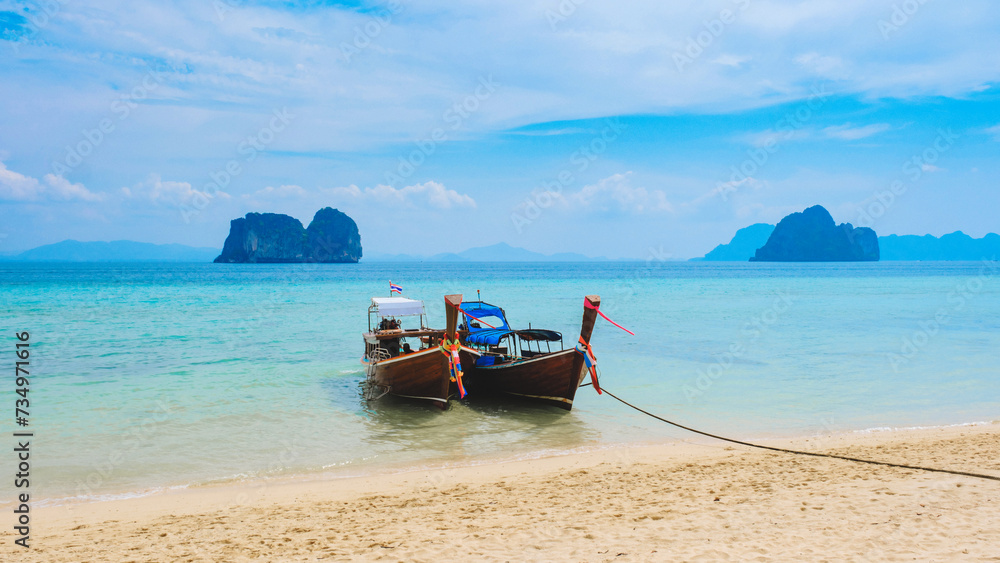 Obraz premium Longtail boats on the beach of Koh Ngai island with soft white sand, and a turqouse colored ocean, Koh Ngai Trang Thailand