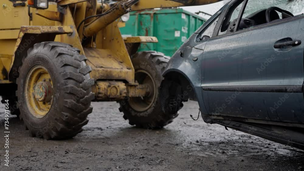 Forklift stacks cars into pile in junk yard close up with fork tidying up scrap vehicles. a Bulldozer moves a broken car through a landfill in rainy weather, slow motion Forklift stacks cars into pile in junk yard close up with fork tidying up scrap vehicles. a Bulldozer moves a broken car through a landfill in rainy weather, slow motion