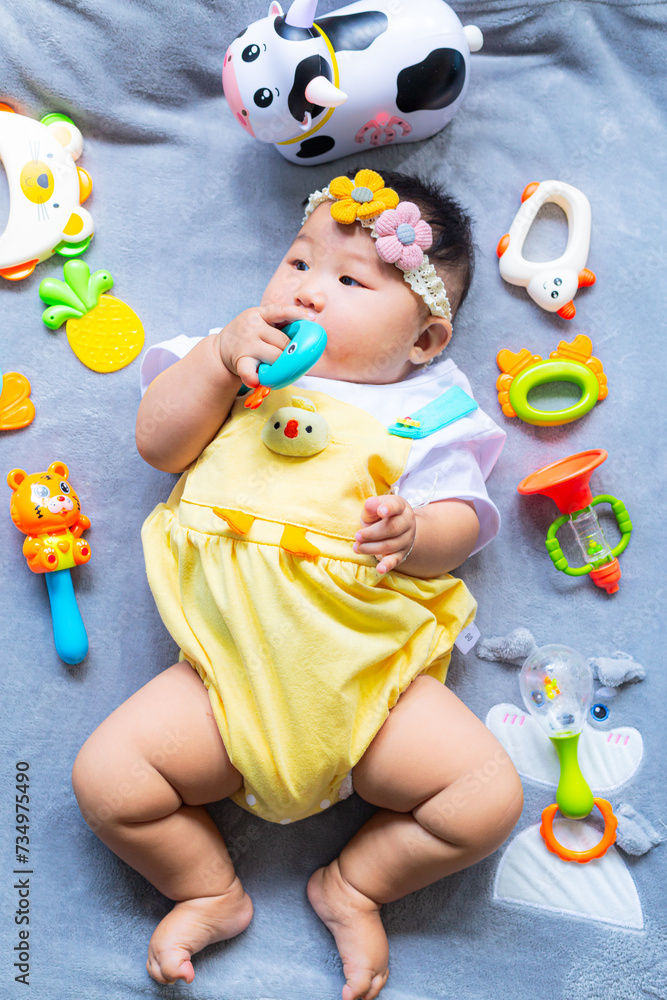 Obraz premium Baby in cute outfit with toys,Little girl 3-6 months old in cute outfits