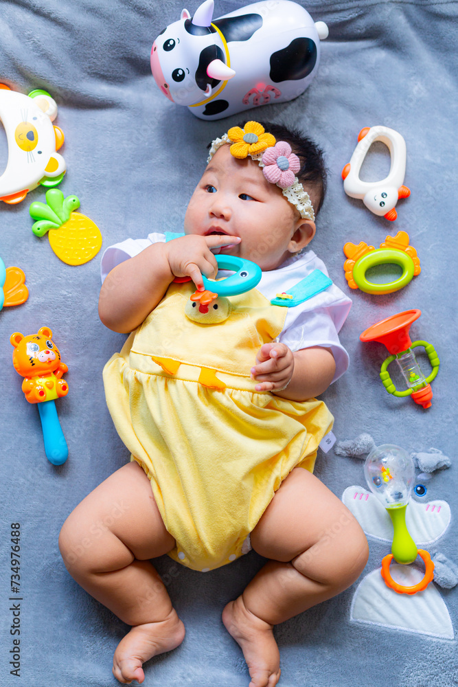 Obraz premium Baby in cute outfit with toys,Little girl 3-6 months old in cute outfits