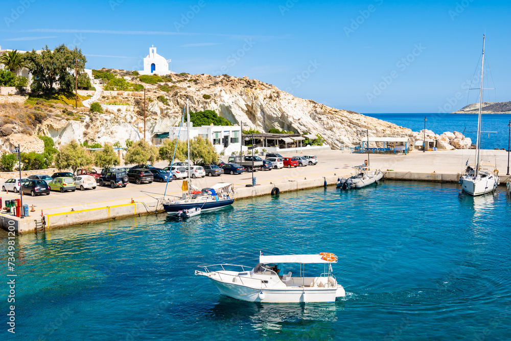 View of Kimolos port with white church and sea bay, Kimolos island, Cyclades, Greece