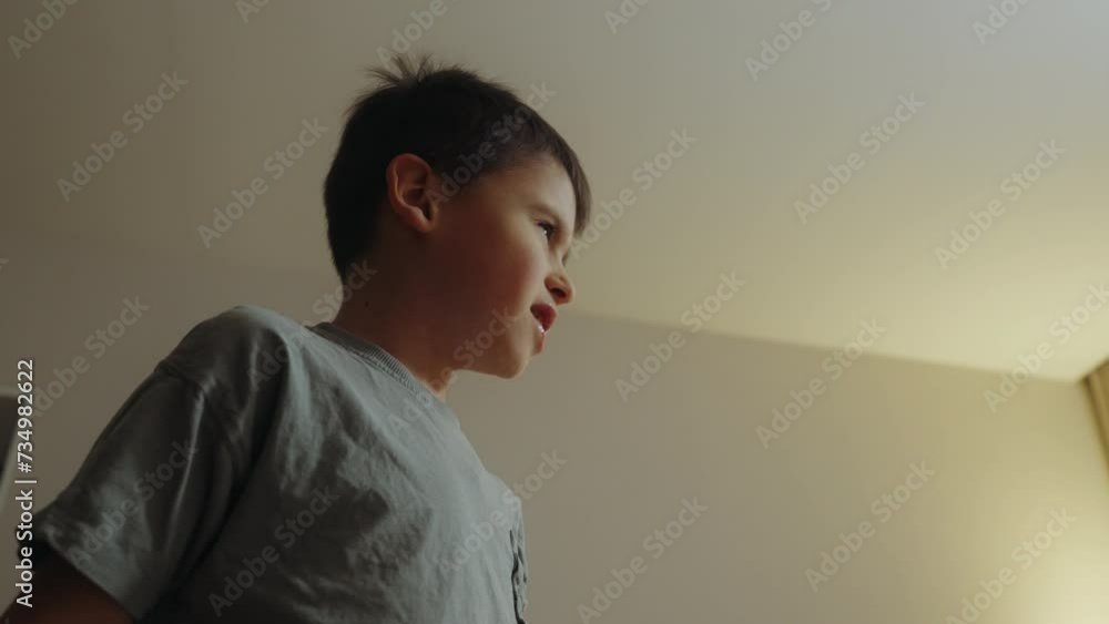 Playful boy gesturing while playing alone at home. Playful boy gesturing while playing alone at home.