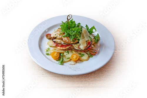 White plate with mozzarella and vegetables on white