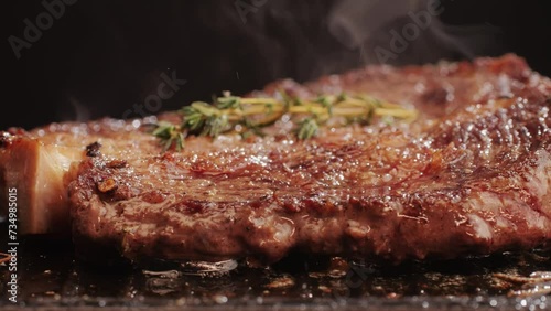 Fresh marbled beef with pepper, salt and rosemary close-up macro. Cooking juicy steak on grill with oil. Premium organic wagyu meat photo