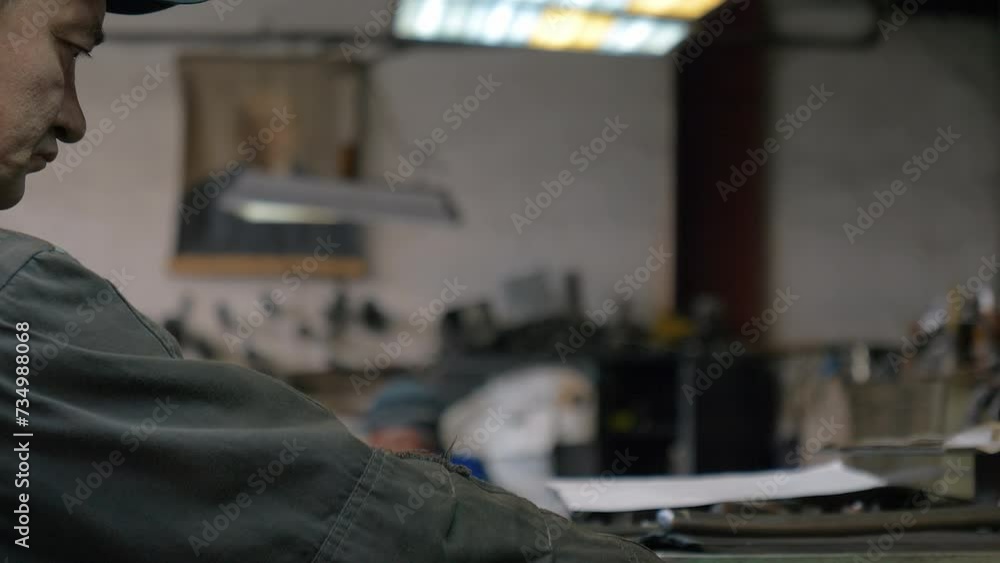 Metallurgist Pulls Handle To Operate Metal Processing Equipment. Rotating Mechanism For Metal Processing. Industrial Production Equipment. Worker Uses Equipment For Metal Processing. Manufacturing Metallurgist Pulls Handle To Operate Metal Processing Equipment. Rotating Mechanism For Metal Processing. Industrial Production Equipment. Worker Uses Equipment For Metal Processing. Manufacturing