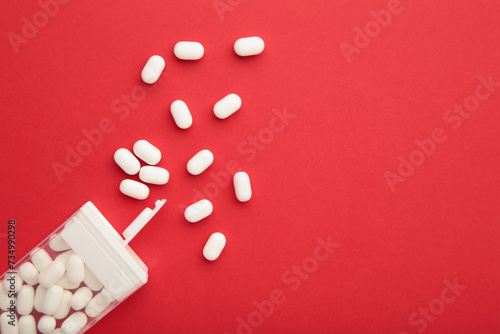 Tasty mint dragee candies with box on red background. Space for text