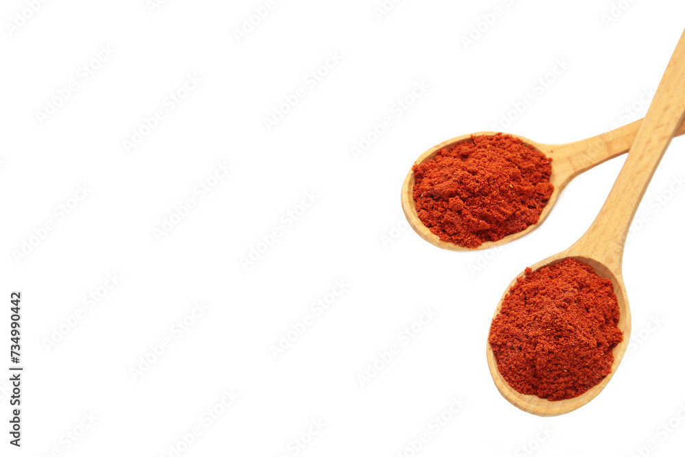 Powder paprika with wooden spoon isolated on white background Powder paprika with wooden spoon isolated on white background