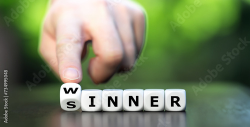 Hand turns dice and changes the word sinner to winner. Symbol for stop being a sinner and become a winner.