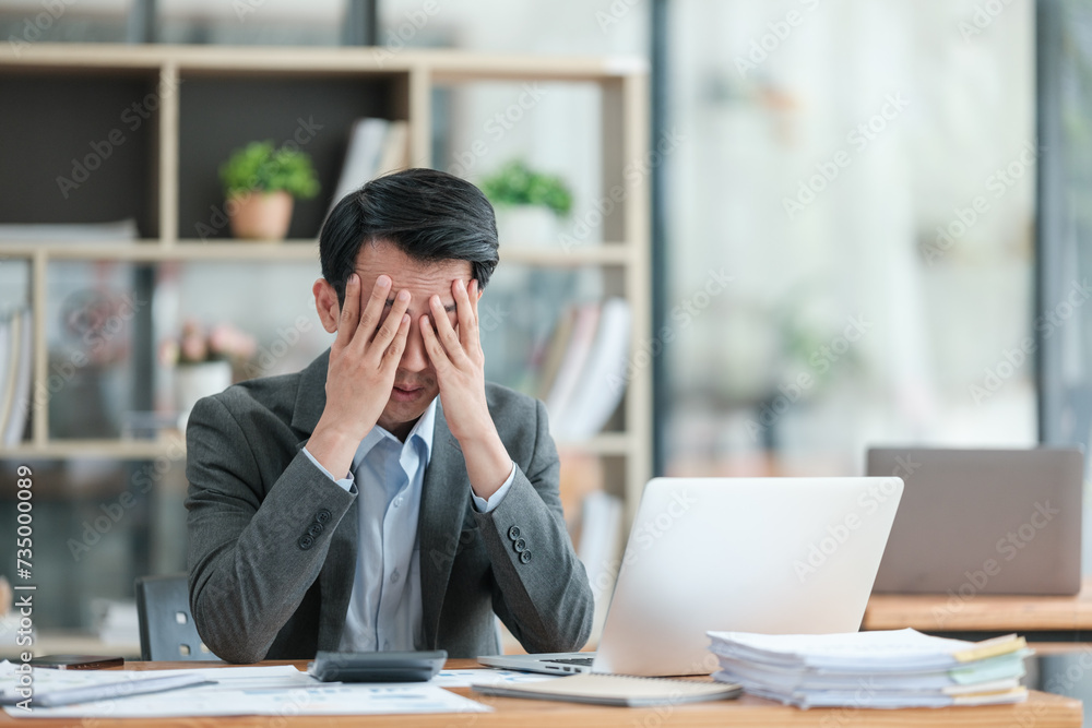 Young Stressed Out Businessman Using Laptop Computer in Modern Office. Manager Thinks About Successful Financial Ideas. Happy Man Smiling About Finding Problem Solving Solutions for Company. Young Stressed Out Businessman Using Laptop Computer in Modern Office. Manager Thinks About Successful Financial Ideas. Happy Man Smiling About Finding Problem Solving Solutions for Company.