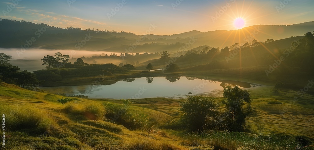 The morning sun bathes the landscape in a soft golden glow, illuminating rolling hills and tranquil lakes shrouded in mist, creating a breathtaking panorama of serenity.