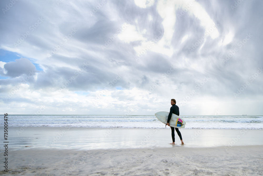 Surfboard, ocean and man on beach for surfing on vacation, holiday and weekend for wellness. Travel mockup, fitness and person for water sports, hobby and exercise for adventure and training in sea Surfboard, ocean and man on beach for surfing on vacation, holiday and weekend for wellness. Travel mockup, fitness and person for water sports, hobby and exercise for adventure and training in sea