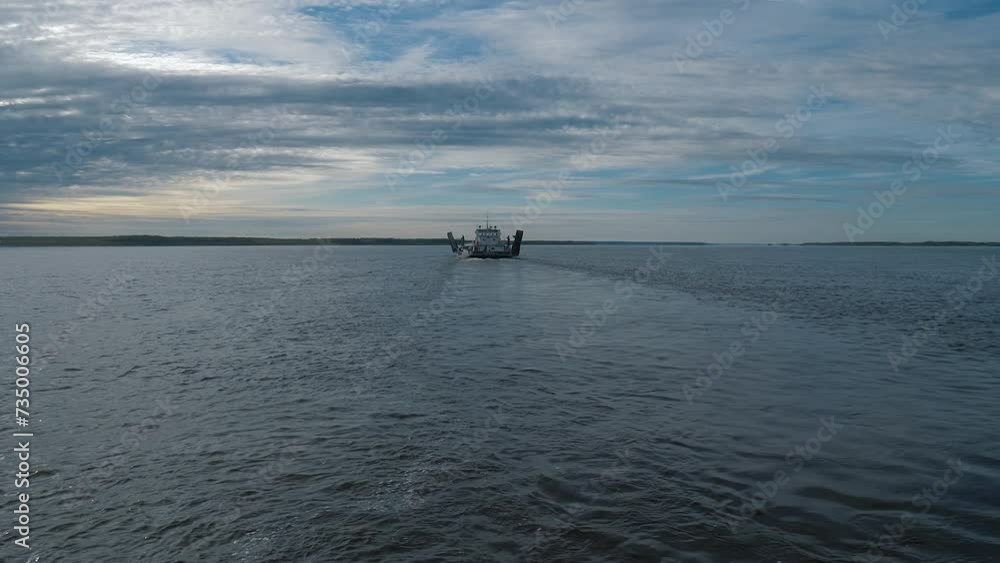 Naval boat exporting the goods sailing on the clear lake water. Boat on water transporting the export goods products to the shore. Industrial boat moving the export goods through the water Naval boat exporting the goods sailing on the clear lake water. Boat on water transporting the export goods products to the shore. Industrial boat moving the export goods through the water
