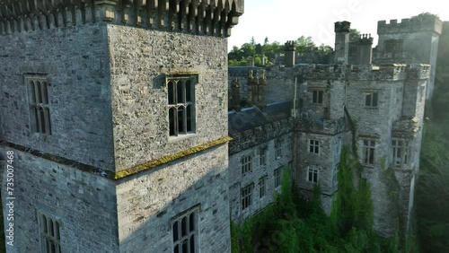 A picturesque castle against the landscape. River and lawn in front of Lismore Castle photo