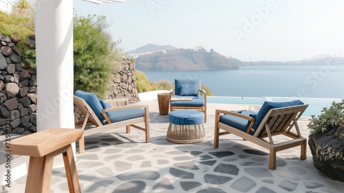 A tranquil resort terrace featuring comfortable seating and a stunning view of the Aegean Sea captured under clear skies.