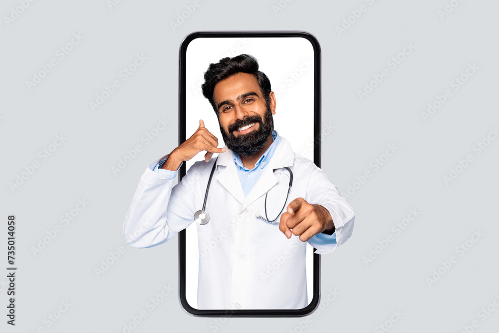 Indian male doctor in phone frame making call sign Indian male doctor in phone frame making call sign
