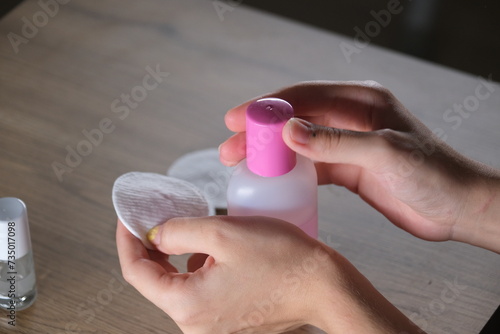 woman using acetone and cotton for care photo