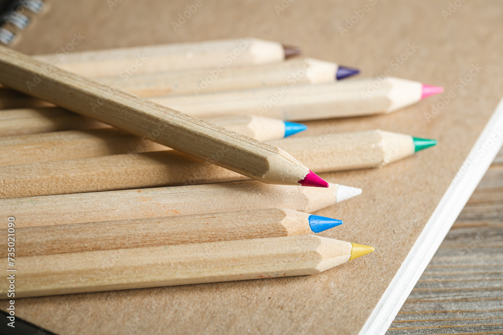 Colored eco wooden pencils on a wooden background. Educational or back to school concept. Macro shot. Colored eco wooden pencils on a wooden background. Educational or back to school concept. Macro shot.
