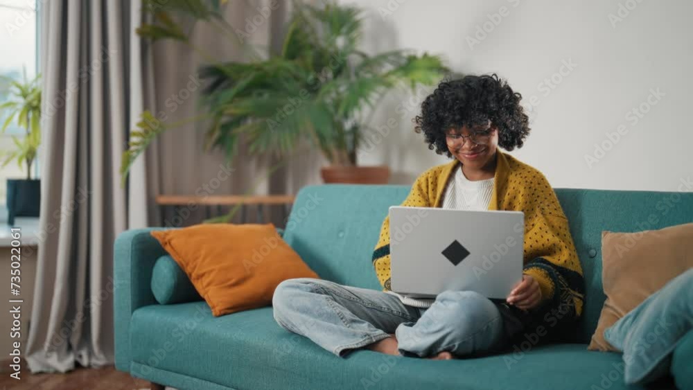 Friendly african american woman working on laptop, typing messages chatting with colleagues. Serious positive curly relaxed female enjoying work and online communication on laptop, computer. Friendly african american woman working on laptop, typing messages chatting with colleagues. Serious positive curly relaxed female enjoying work and online communication on laptop, computer.