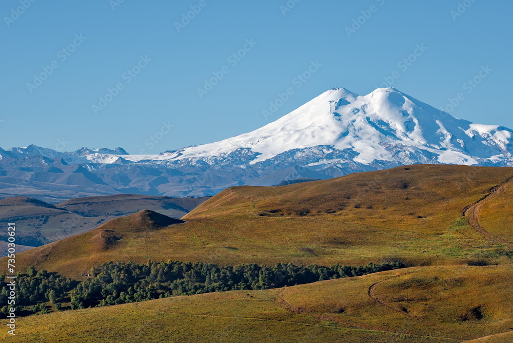 Fototapeta premium Russia, the Elbrus region. Amazing view of the snow-capped peaks of Elbrus (5642 m) from the side of the Gily-Su tract.