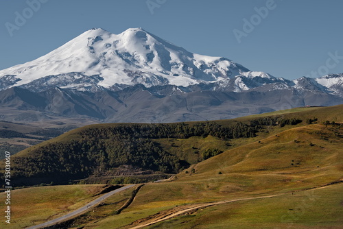 Russia, the Elbrus region. Amazing view of the snow-capped peaks of Elbrus (5642 m) from the side of the Gily-Su tract. photo