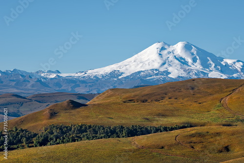 Russia, the Elbrus region. Amazing view of the snow-capped peaks of Elbrus (5642 m) from the side of the Gily-Su tract.