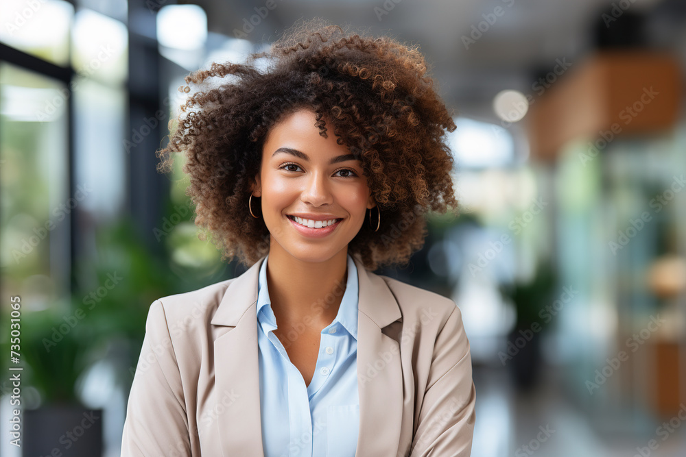 Happy young African American business woman. Shot of business young afro woman in the modern office. Smiling successful African American Woman. Successful Entrepreneurship.