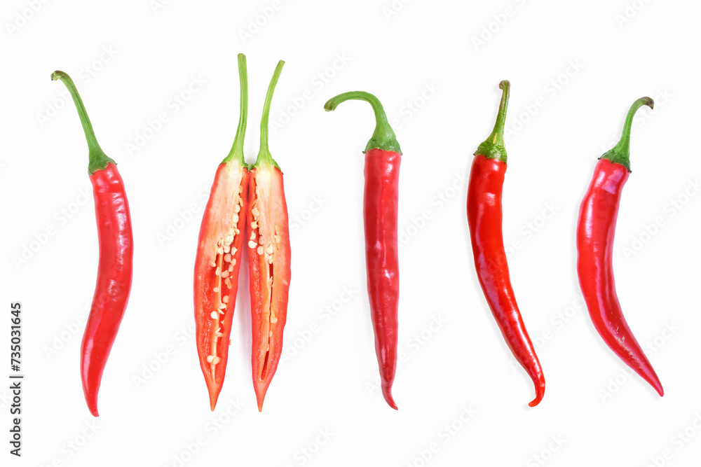 Red hot chili peppers. Chili pepper sliced, cross section. Four red long hot peppers and one chilli pepper sliced in half