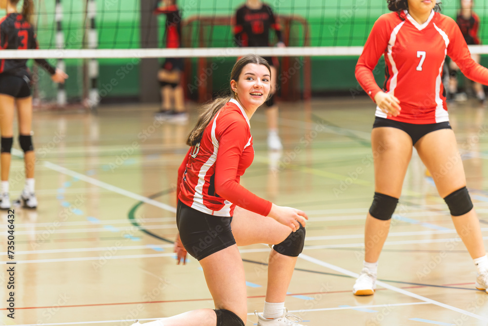 Naklejka premium teen volleyball player in gymnase play her sport
