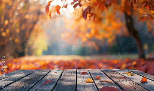 The empty wooden table top with blur background of autumn. Exuberant image