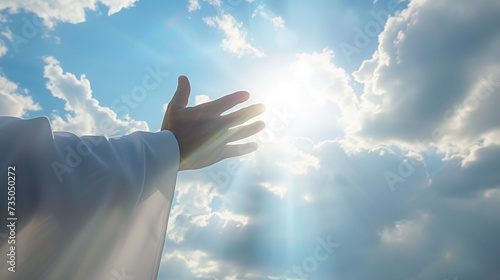 Spiritual Awakening: Hand Reaching for the Sunlight Through Clouds - Symbol of Hope, Faith, and Enlightenment © Michael