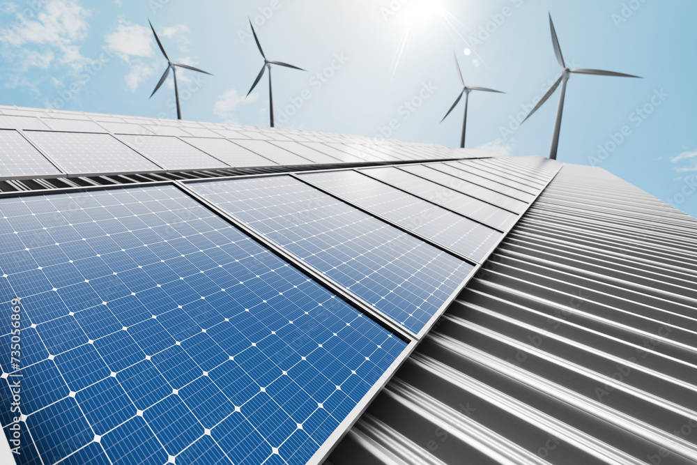 Solar panels mounted on a factory's metal sheet roof with a wind turbine in the background, set against a clear blue sky background - obrazy, fototapety, plakaty 