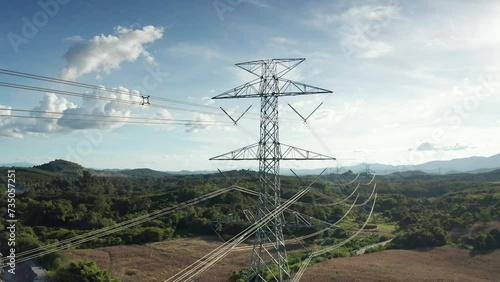 Transmission tower in aerial view. May called electricity pylon, steel utility pole consist of steel structure framing to support carry high-voltage cable or overhead power line for electrical grid.