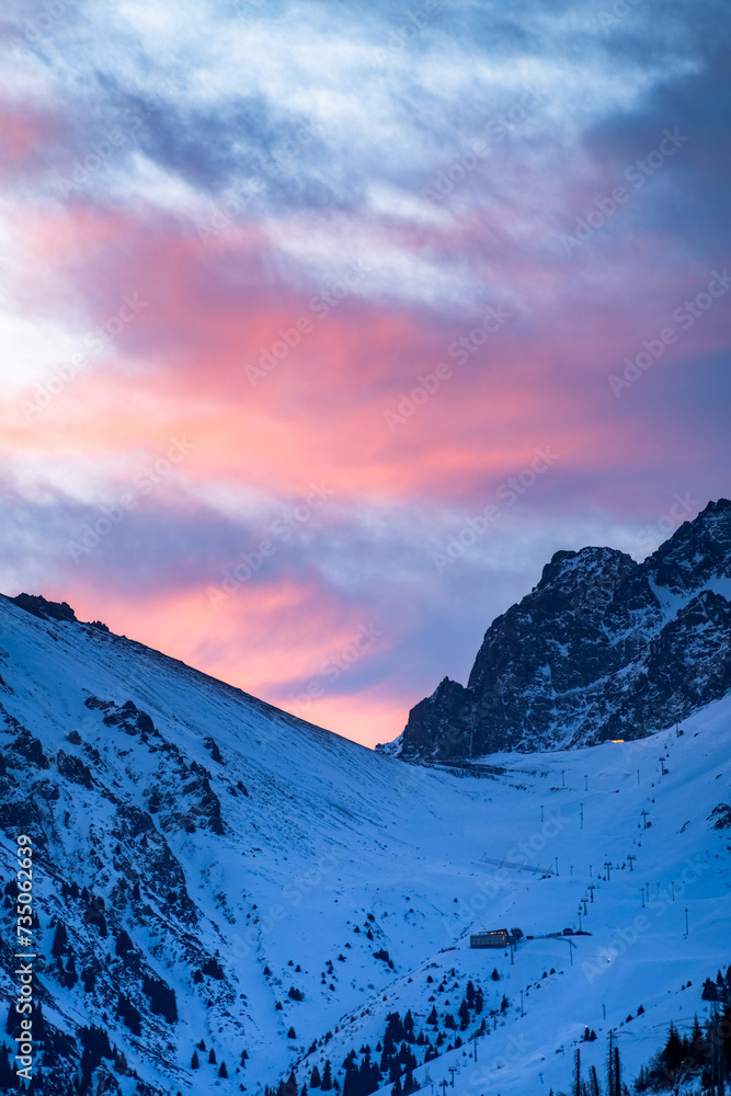 a beautiful pink dawn in the snowy mountains. early morning in the winter mountains