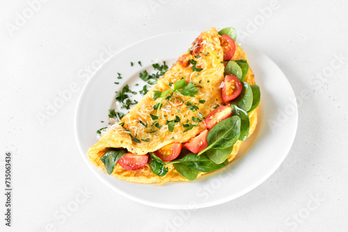 Breakfast omelette with spinach and tomato